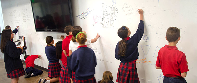 photo of children drawing on a ZURB whiteboard wall